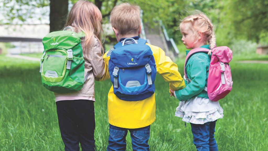 Young children camping outdoors